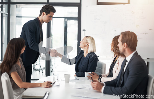 Image of Business people, handshake and meeting for greeting, introduction or partnership in conference at office. Businessman shaking hands with woman in teamwork, b2b or deal for agreement at the workplace