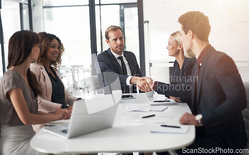 Image of Business people, handshake and meeting for hiring, partnership or agreement in team conference at office. Businessman shaking hands with employee for recruiting, b2b and corporate growth at workplace