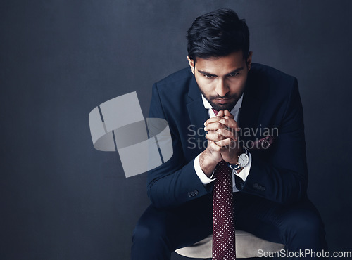 Image of Business, thinking or Indian man with stress, anxiety or employee on a dark studio background. Male person, entrepreneur or consultant confused, planning or professional with company report or worry