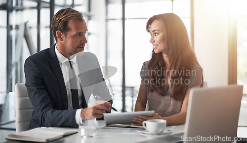 Image of Laptop, partnership or training with a mentor and employee in the boardroom for an introduction to the business. Teamwork, coaching or collaboration with a male manager talking to a woman colleague