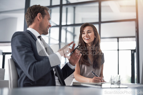 Image of Discussion, partnership and business people writing in the office while doing research or planning. Brainstorming, meeting and professional designers working on a creative project in the workplace.