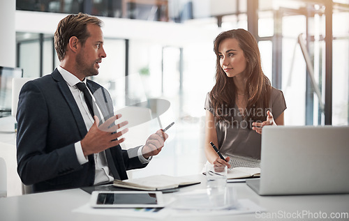 Image of Laptop, collaboration or training with a mentor and employee in the boardroom for an introduction to the business. Teamwork, coaching or partnership with a male manager talking to a woman colleague