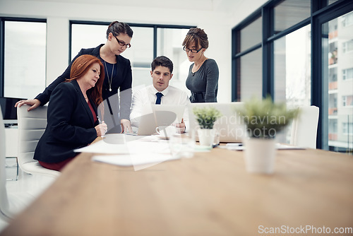 Image of Laptop, collaboration and business people in a meeting in the office conference room for planning. Technology, teamwork and group of colleagues brainstorming and working on a project in the workplace