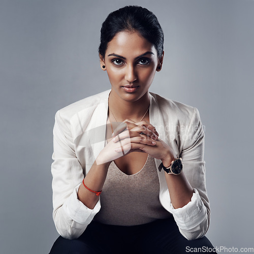 Image of Confident, portrait of a businesswoman and against a studio background for success. Elegance or assertive, empowerment or proud and female person pose for positive mindset against a backdrop