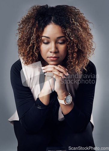 Image of Stress, thinking and young woman in studio with sorrow, grief or mental health problems. Sad, depression and tired female person sitting on a chair with her thoughts isolated by a gray background.