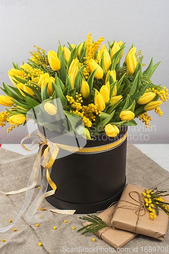 Image of Bright spring bouquet of tulips and mimosa flowers