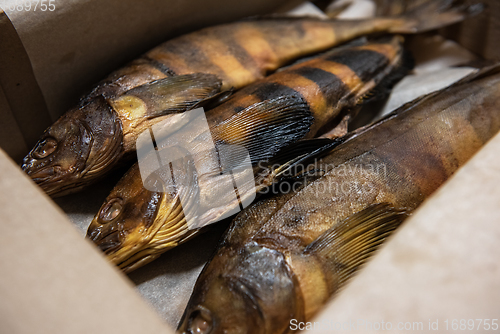 Image of Smoked fish in craft paper box.