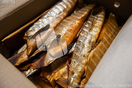 Image of Smoked fish in craft paper box.