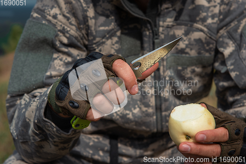 Image of A man with a knife in the forest.