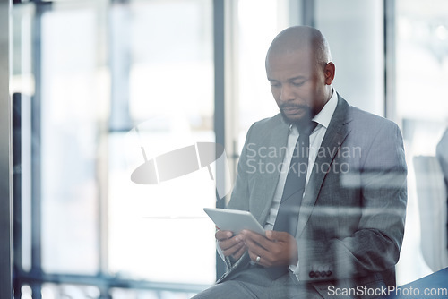 Image of Tablet, lawyer and black man in office for business, research or online browsing. Serious, digital technology and corporate African attorney, person or professional reading email, internet app or web