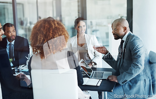 Image of Business people, meeting and leader with corporate team, laptop and workshop with management group. Executive men, women and diversity with ceo, financial strategy and discussion for planning at desk