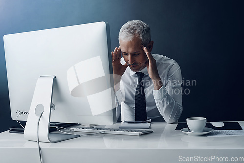 Image of Mental health, mature businessman with headache and against a studio background at his desk. Burnout or migraine pain, mistake or problem and male person stress for bankruptcy or overworked.