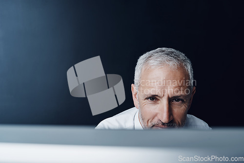 Image of Technology, man working on his computer and against a studio background. Connectivity or social networking, research or website and mature businessman browsing internet at desktop in backdrop