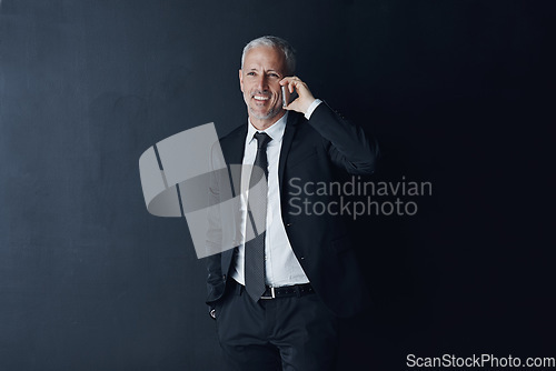 Image of Phone call, happy and mature businessman in a studio for an online corporate or legal consultation. Smile, technology and professional senior male lawyer on a mobile conversation by black background.