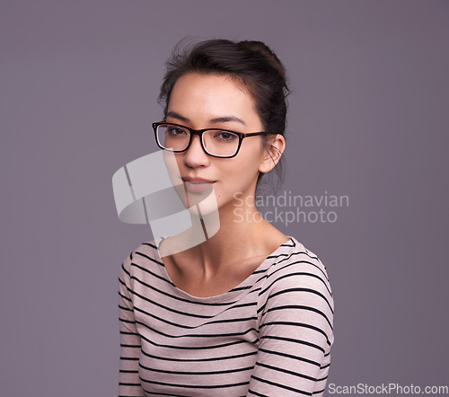 Image of Portrait, fashion glasses and serious woman in studio isolated on a gray background mockup space. Face, nerd and female geek, person or model from Canada with trendy clothes, eyewear and casual style