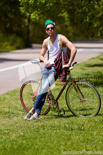Image of Student man, fashion and bicycle at campus with sunglasses, confident and sustainable travel in summer. Young male person, gen z guy and retro bike in sunshine for eco friendly transport at college