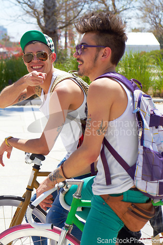 Image of Men, students and friends with back, bicycle and sustainable transportation on road in summer sunshine. Young gen z people, retro bike and outdoor together in street with travel on university campus