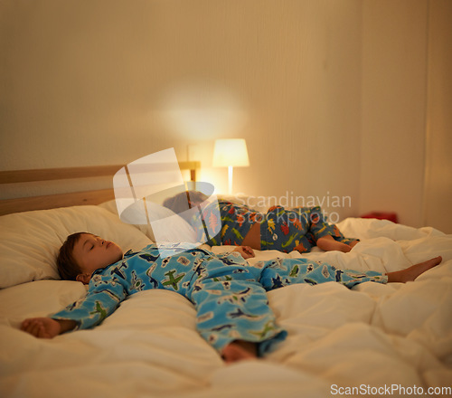 Image of Brothers, sleep and night in bed for rest together, peace and health in family home. Young tired kids, boy children and tired with calm sleeping, fatigue and dream on blanket in bedroom at house