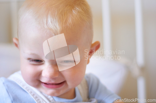 Image of Funny, children and baby in the crib of a nursery in his home for growth, child development or curiosity. Kids, laughing and toddler with a male or boy child standing in his cot looking adorable