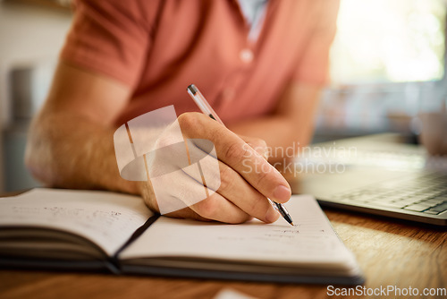 Image of Man, hands and writing on book with pen for notes, schedule planning or strategy on table at home. Closeup hand of male person with notebook for ideas, reminder or information in research or studying
