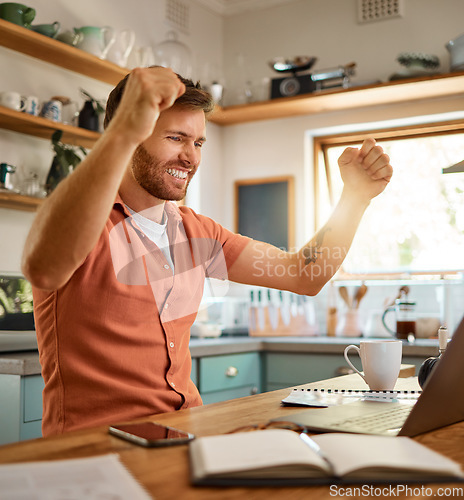 Image of Man, fist and celebration on laptop for success, good news or winning in bonus promotion on table at home. Happy male person or freelancer in joy for victory, sale or discount in lottery or prize