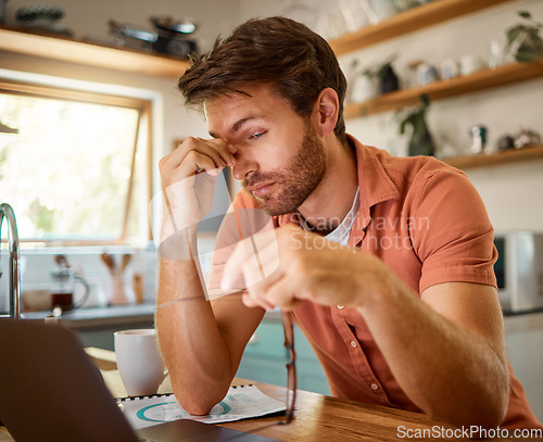 Image of Tired, laptop and business man in kitchen for remote work, freelancer and mental health. Technology glitch, eye strain and frustrated with male person at home for burnout, exhausted and anxiety