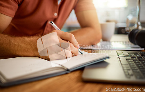 Image of Man, hands and writing on book for notes, schedule planning or strategy on table at home. Closeup hand of male person with pen and notebook for ideas, reminder or information in research or studying