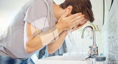 Image of Man, bathroom and washing face at tap, water and morning skincare routine for grooming, beauty wellness or at home. Young guy, facial and cleaning at faucet, basin and wet splash for personal hygiene