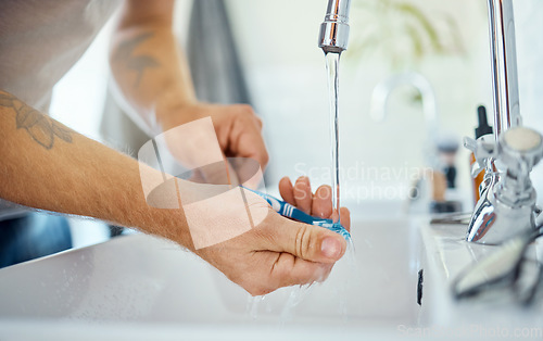 Image of Hands, toothbrush or man at sink of water, dental hygiene or wellness of gum care at home. Closeup of person washing oral product for brushing teeth, fresh morning routine or cleaning at bathroom tap