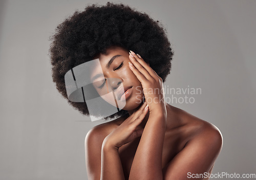 Image of African, woman and skincare with feeling and facial treatment or wellness in studio background. Beauty, dermatology and hands on face with glowing, clear and healthy skin for self care with afro.