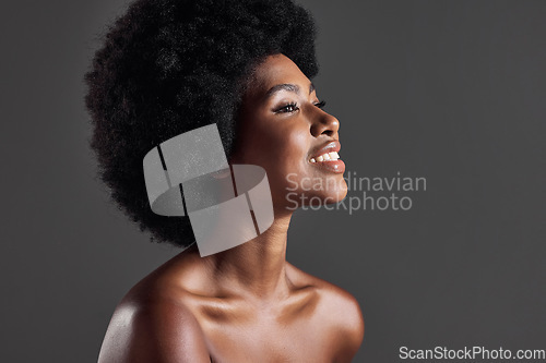 Image of Hair, smile and profile of black woman with afro hairstyle, beauty and skincare on grey background. Haircare, cosmetics and beautiful face of happy African model with skin glow and shine in studio.