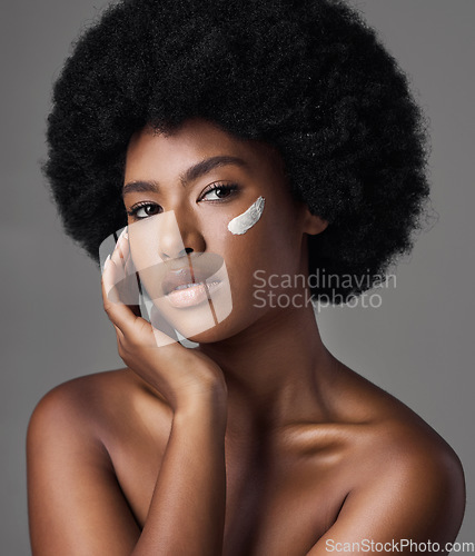 Image of Black woman in portrait, cream and beauty with skincare and cosmetics product on studio background. Natural, afro hairstyle and African female model, dermatology with lotion and facial moisturizer
