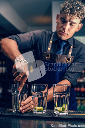 Image of Bartender squeezing ripe limes