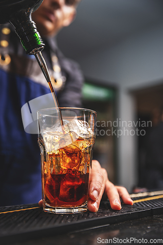 Image of Barman pouring liquor