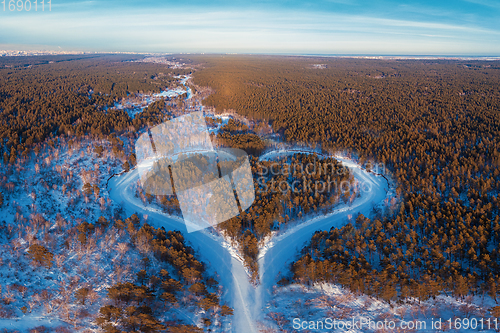 Image of Aerial view of a heart shaped winter forest