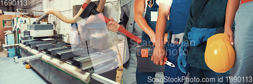 Image of Workers with tools on wooden furniture production