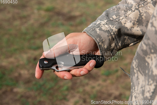 Image of A man with a knife in the forest.