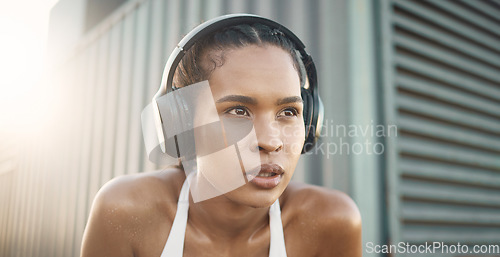 Image of Headphones, woman thinking or tired runner in city listening to music to start training, workout or exercise. Face, resting break or healthy sports girl athlete streaming fitness podcast to relax