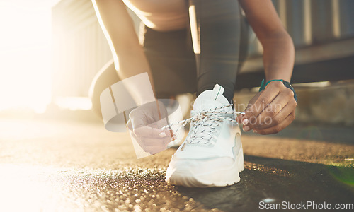 Image of Tie, street or hands of person with shoelace for fitness training, exercise or running workout on road. Lace, zoom or leg of sports athlete with footwear ready to start exercising on ground in city