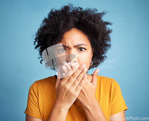 Image of Surprise, shock and portrait of a woman in studio with a wtf, omg or wow face expression. Shocked, emotion and headshot of young female model with scared gesture or emoji isolated by blue background.