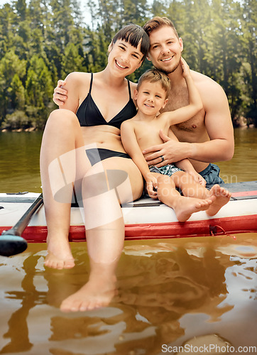 Image of Lake, family on paddle board and relax outdoor, summer holiday and travel in portrait. Adventure, freedom and fun, man and woman with boy child in swimsuit, vacation and bonding together in nature