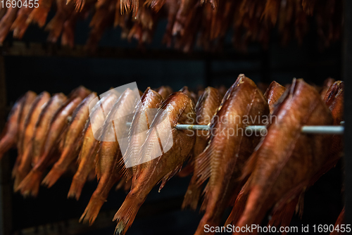 Image of Smoking sea bass fish in smokehouse box