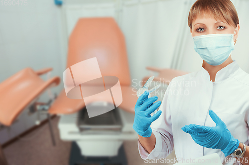 Image of Female gynecologist in protective mask