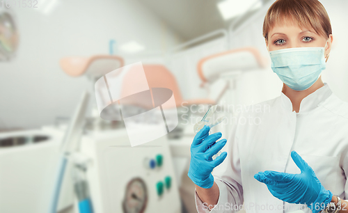 Image of Female gynecologist in protective mask