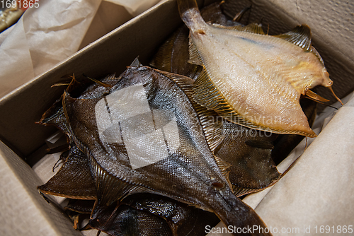 Image of Smoked fish in craft paper box.