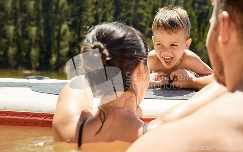 Image of Happy, family with boat and in lake together with smile for bonding time. Summer vacation or holiday break, happiness or kayak and people in a river with canoe activity for adventure or wellness