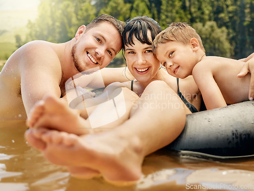 Image of Family, portrait and swimming in lake with happiness in nature, parents and child on summer vacation. Tube, adventure and fun outdoor with man, woman and boy in water with smile, travel and holiday