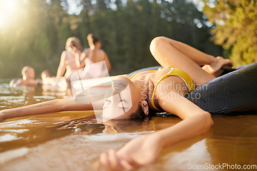 Image of River, tube or woman in nature to relax with carefree fun, peace or holiday weekend in summer. Eyes closed, resting break or calm girl in lake water or dam to float outdoors on vacation trip