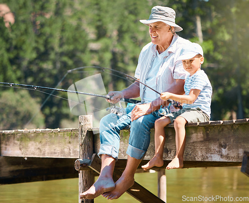 Image of Grandfather, boy and fishing rod at lake for hobby, adventure and teaching about nature. Young child, senior man and learning to fish at water by river dock, weekend camping trip and outdoor holiday