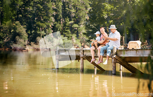 Image of Father, grandfather and child fishing at lake together for fun bonding or peaceful time in nature outdoors. Dad, grandpa and kid enjoying life, catch or fish with rod by water pond or river in forest